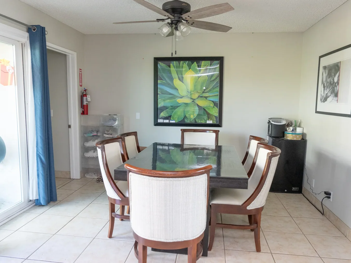 Bright dining room with glass table and comfortable seating for communal meals