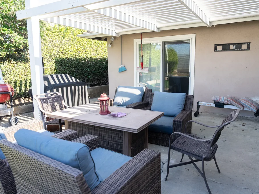 Comfortable outdoor patio area with seating and shade structure