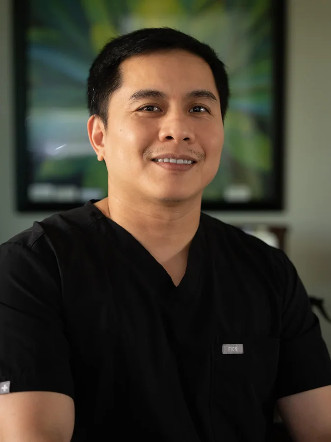 Smiling healthcare professional in black medical scrubs